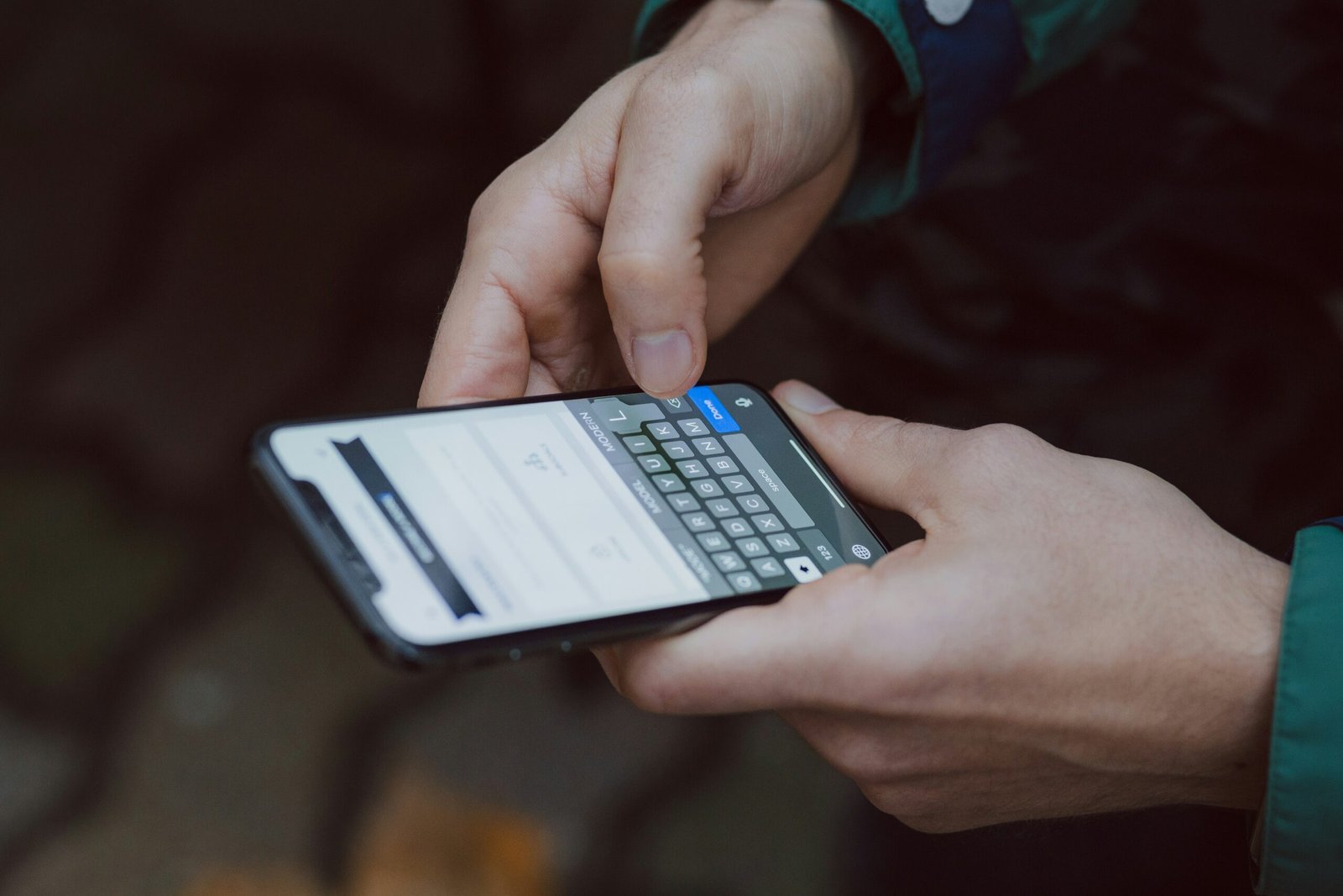 Man typing on a smartphone.